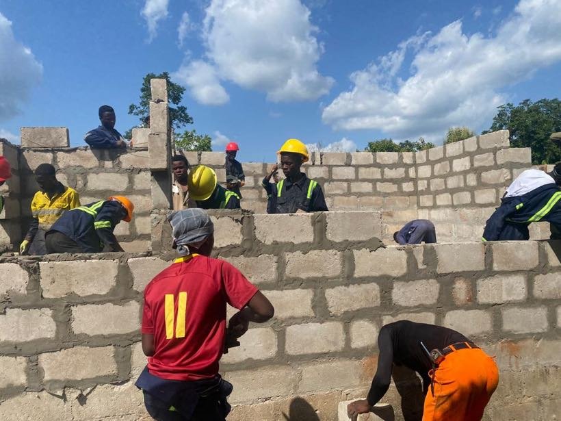 Students laying blocks on a construction practical