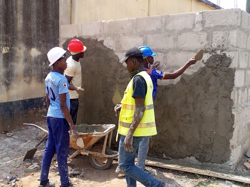 Students setting out foundations on a building site