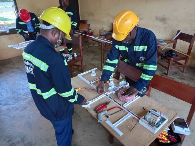 Students wiring a practice board in the electricals workshop