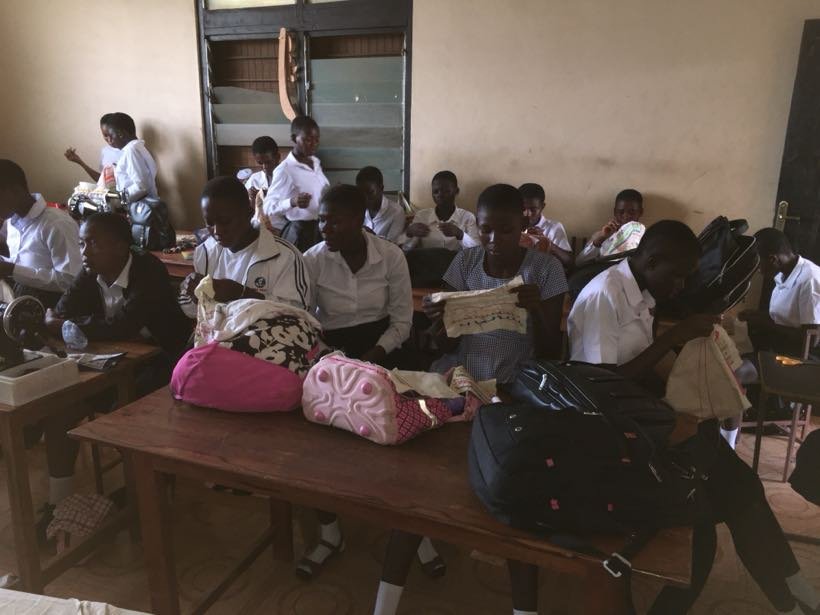 Students in the fashion classroom with their work