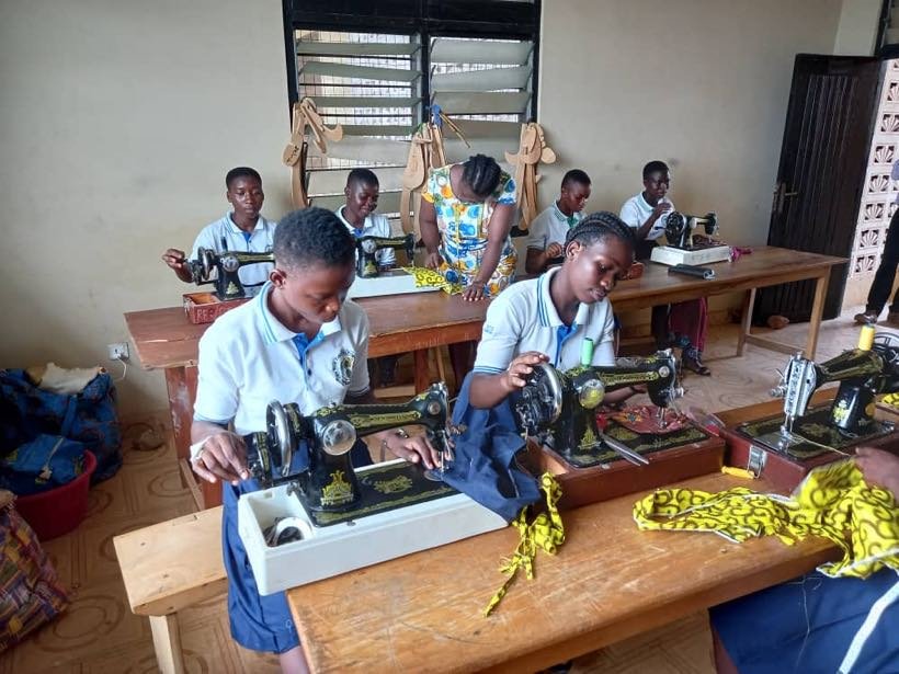 Students at sewing machines in the fashion design studio