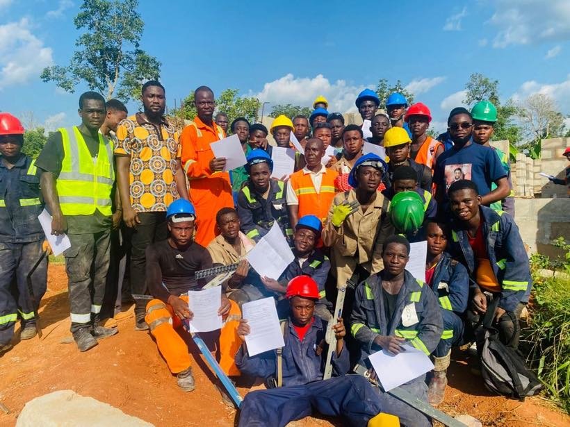 Students and instructors in protective gear at a construction practical