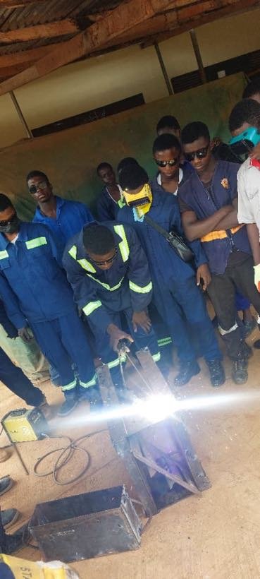 A group of students around a welding bench