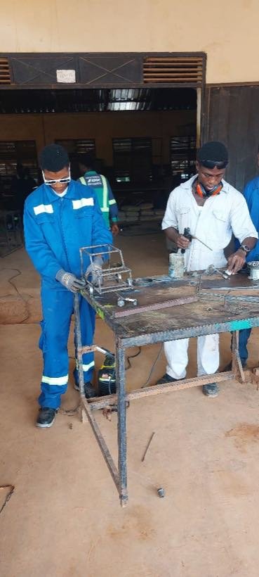 Students assembling a metal frame in the welding bay