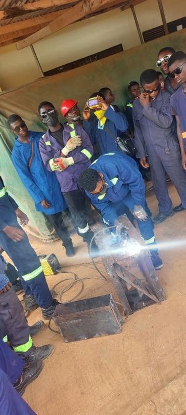 Students observing a welding demonstration